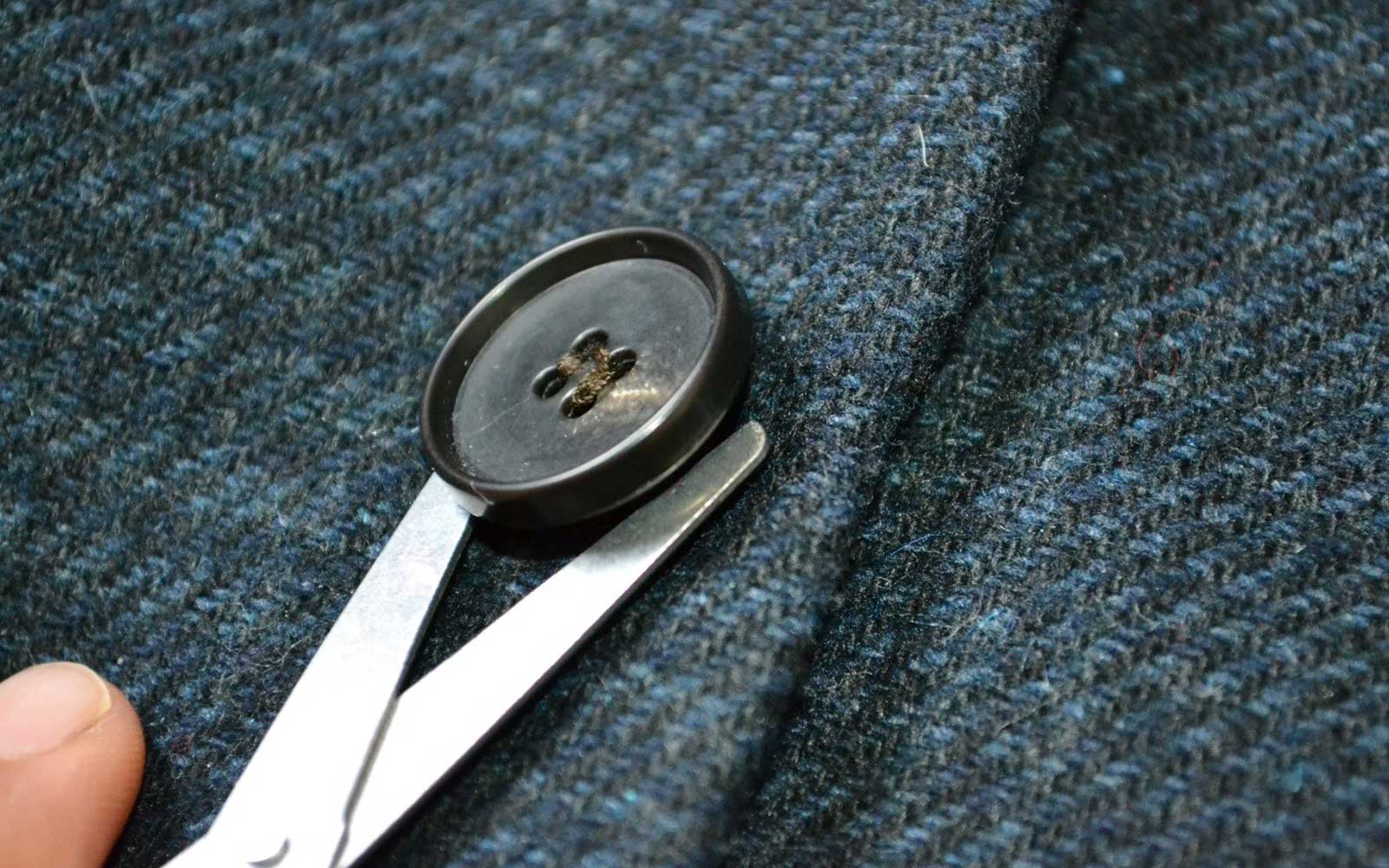 sewing a button on a blazer